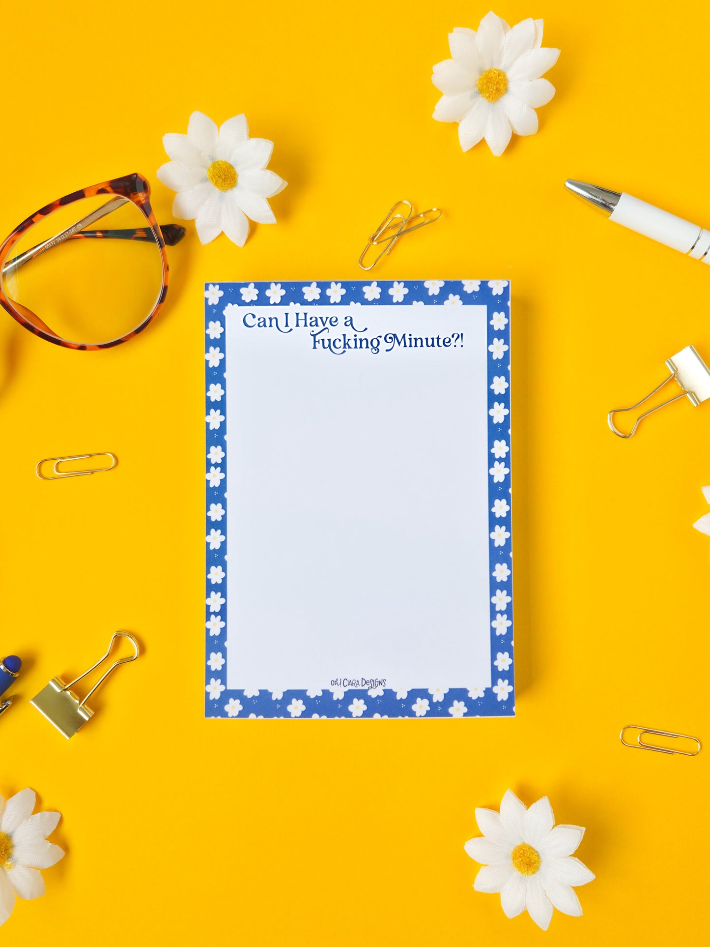 Notepad with text on a yellow background with office supplies