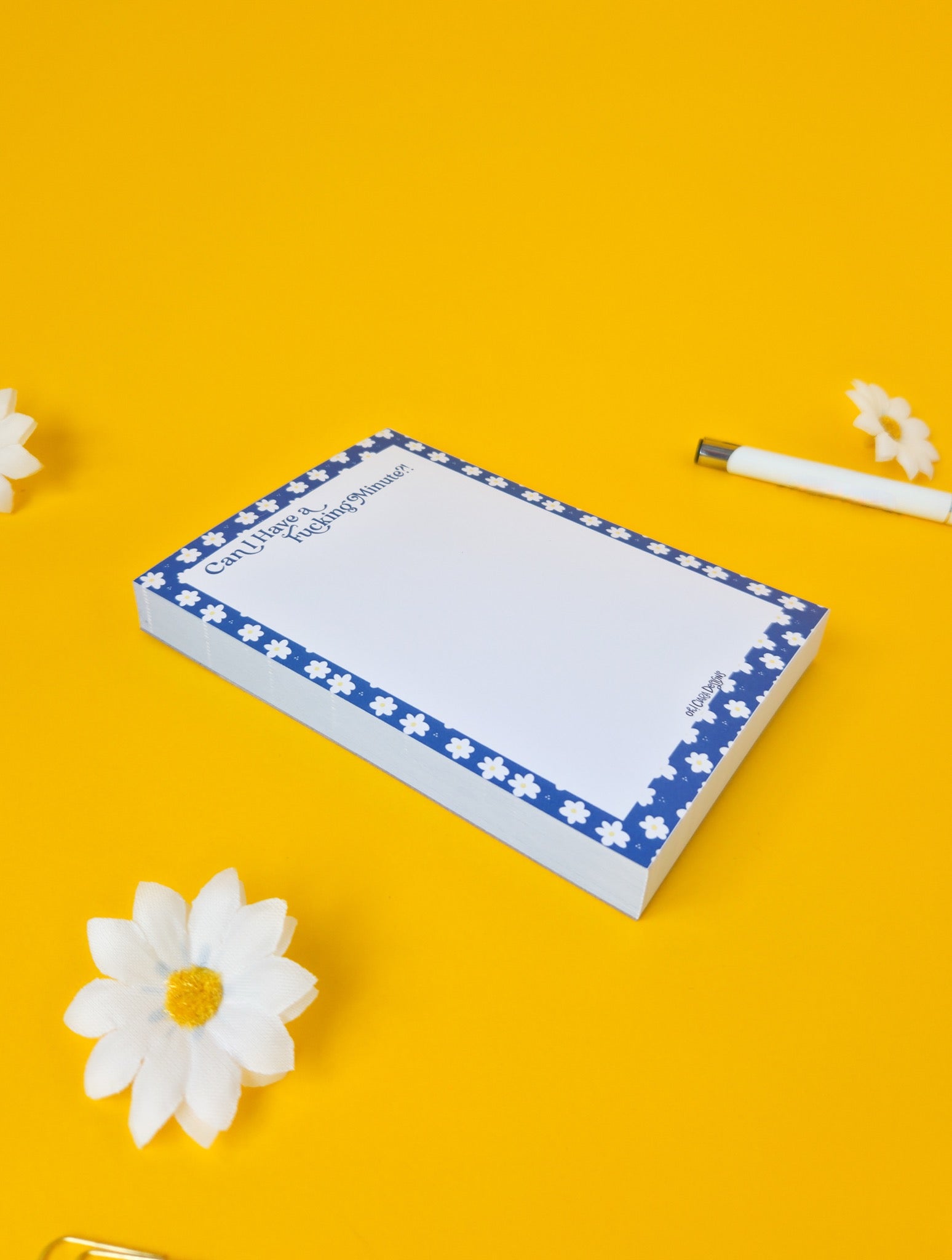 Notepad with floral border on a yellow background