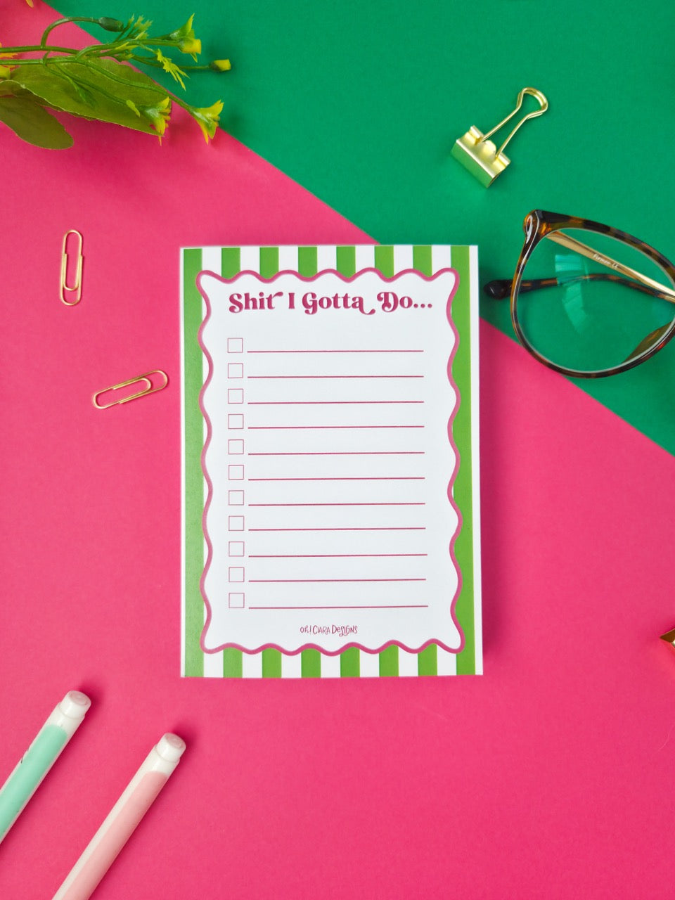 Notepad with a humorous title on a colorful background with office supplies.